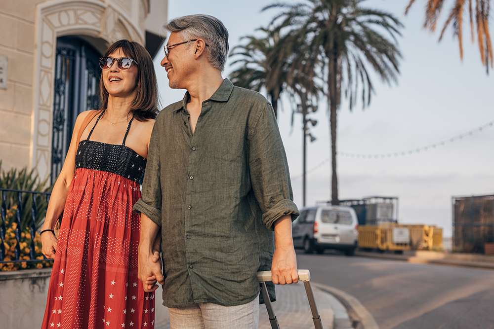 Happy couple walking outdoors by sea