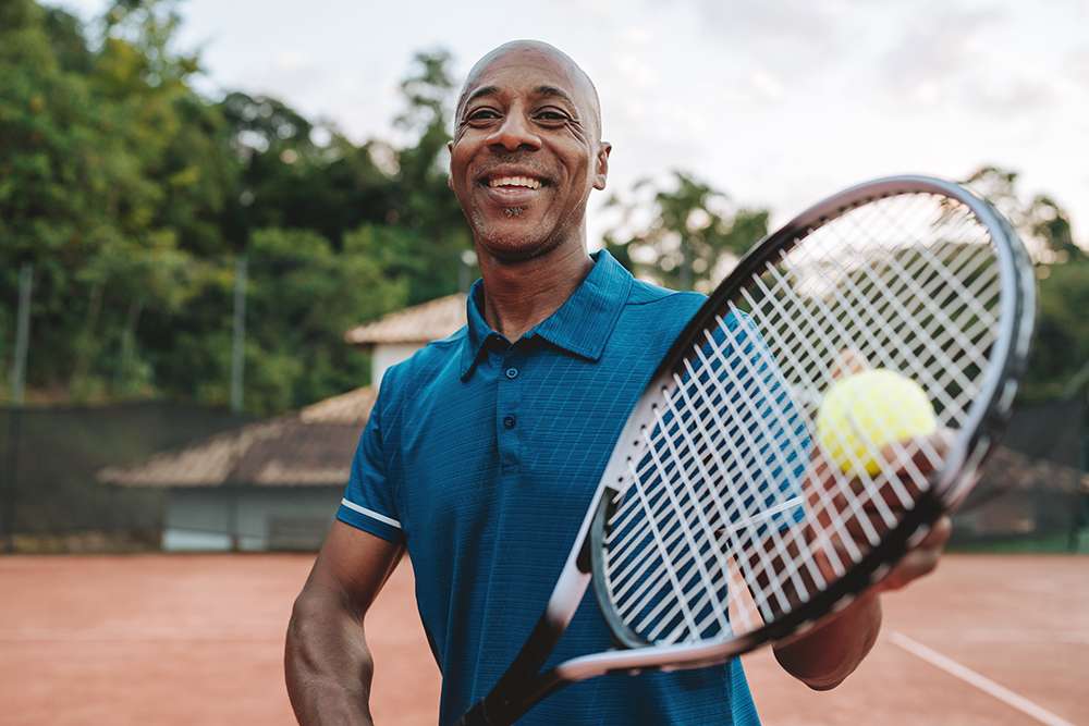Portrait of a man holding tennis racket